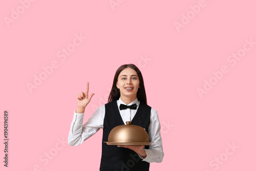 Waitress with metal tray an...