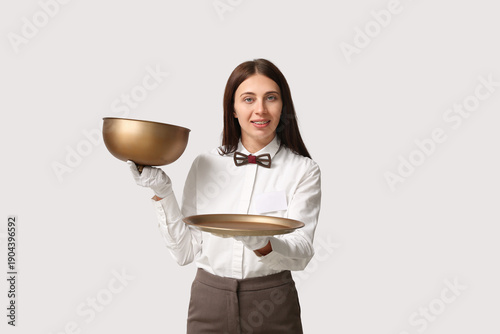 Waitress with metal tray an...