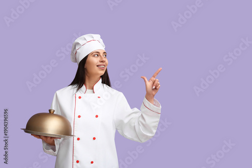 Female chef with metal tray...