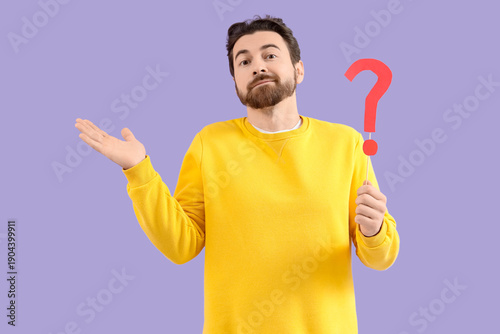 Canvastavla Bearded man with question mark on lilac background