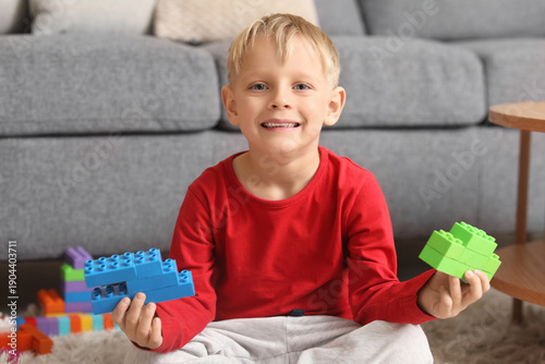 Happy cute little boy playi...