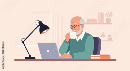 Elderly man drinking coffee while working on laptop at desk