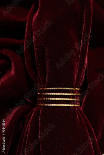 Indian gold bangles on red velvet scarf
