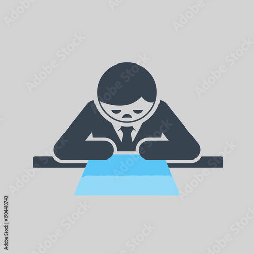 Sad businessman looking down at a glowing document on a table.