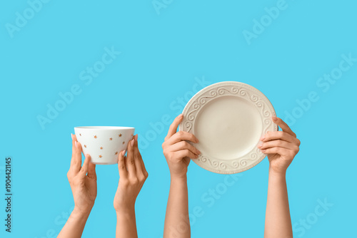 Hands holding empty plate a...
