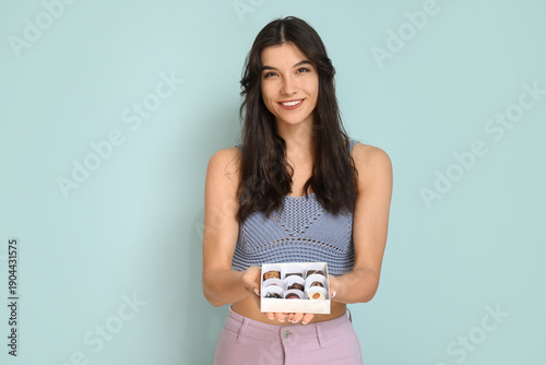Happy young woman with box ...