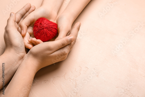 Hands of woman and child wi...