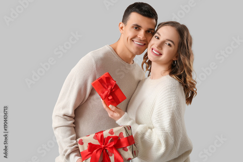 Young couple with gifts for...