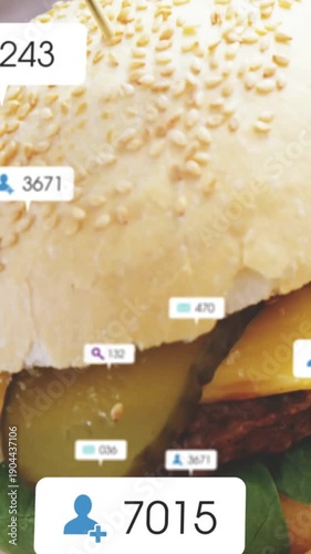 Vertical video: Sandwich closeup starting badges popping, camera sliding down showing rising counts