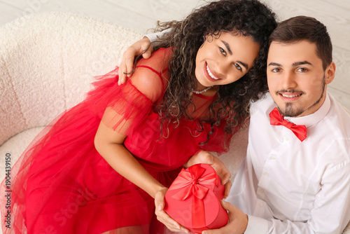 Young couple with gift for ...