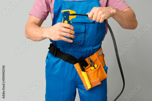 Male electrician with wire ...