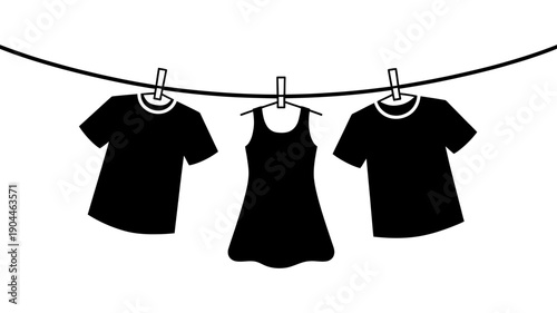 Three black silhouette garments, including two t-shirts and a sleeveless dress, are hanging to dry on a laundry line with clothespins.