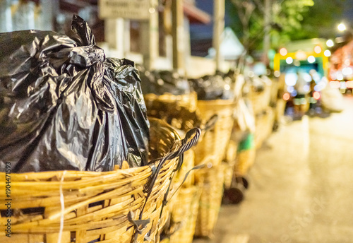 Bamboo askets full of city trash,awaiting collection on the streets of Bangkok,Thailand.