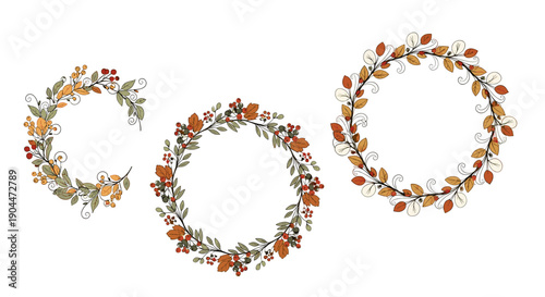 Set of three different floral wreaths and frames made of autumn leaves and red berries on a plain white background.