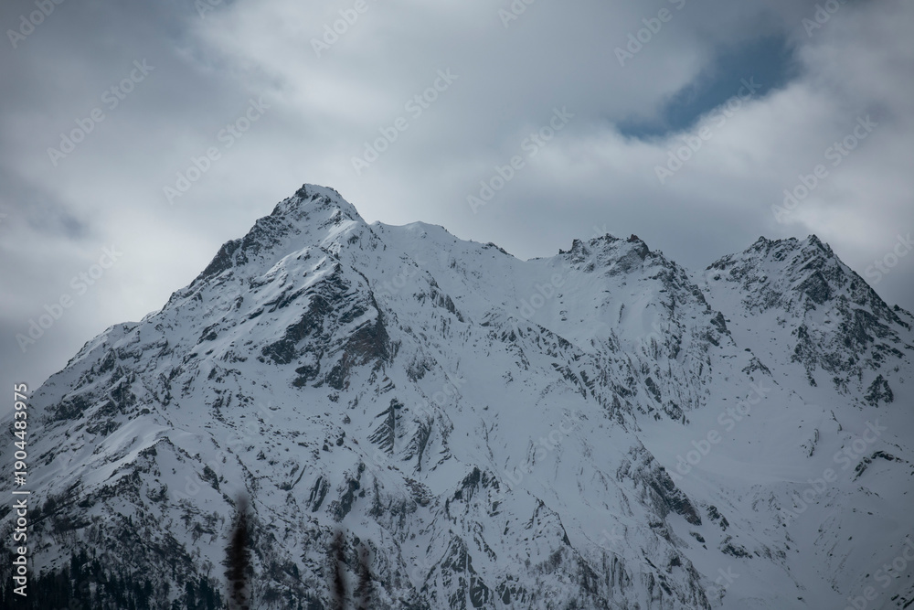 Obraz premium Clouds over snow covered mountains