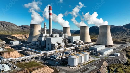 Wallpaper Mural Vast industrial power plant with towering cooling towers emitting plumes of steam under a clear blue sky, showcasing complex machinery and infrastructure. Torontodigital.ca