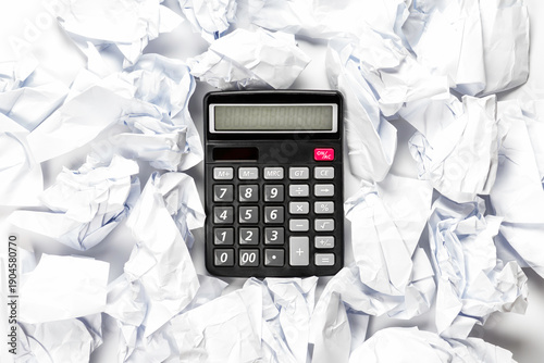 Regular calculator with crumpled sheets of paper.