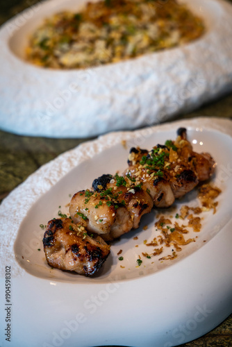 Grilled chicken skewers with sauce  close-up
