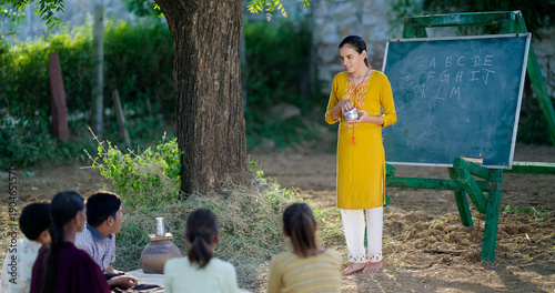 Photography Indian happy female teach boy group do study sitting on mat rural area young gir