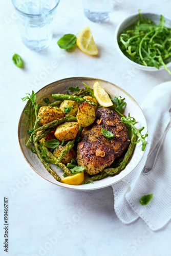 Chicken breast with  baked potatoes and green asparagus