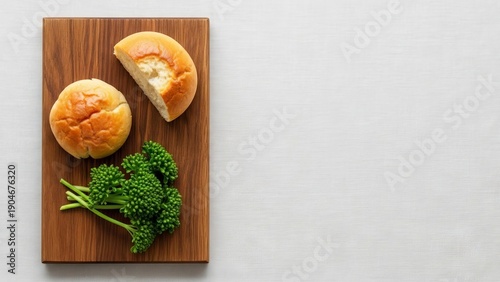 Fresh Broccoli and Baked Bread Rolls on Wooden Cutting Board