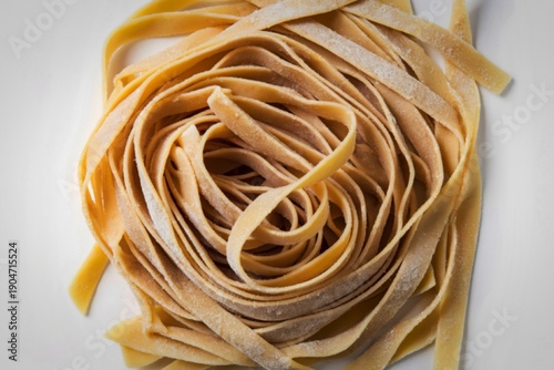 raw tagliatelle pasta isolated on a white background