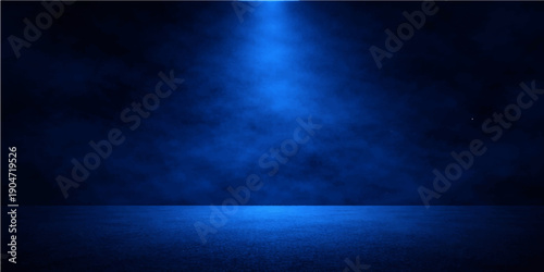 An aged dark blue grunge wall background with a light blue spotlight effect on an empty textured concrete surface featuring a vintage chalkboard pattern and dirty black frame