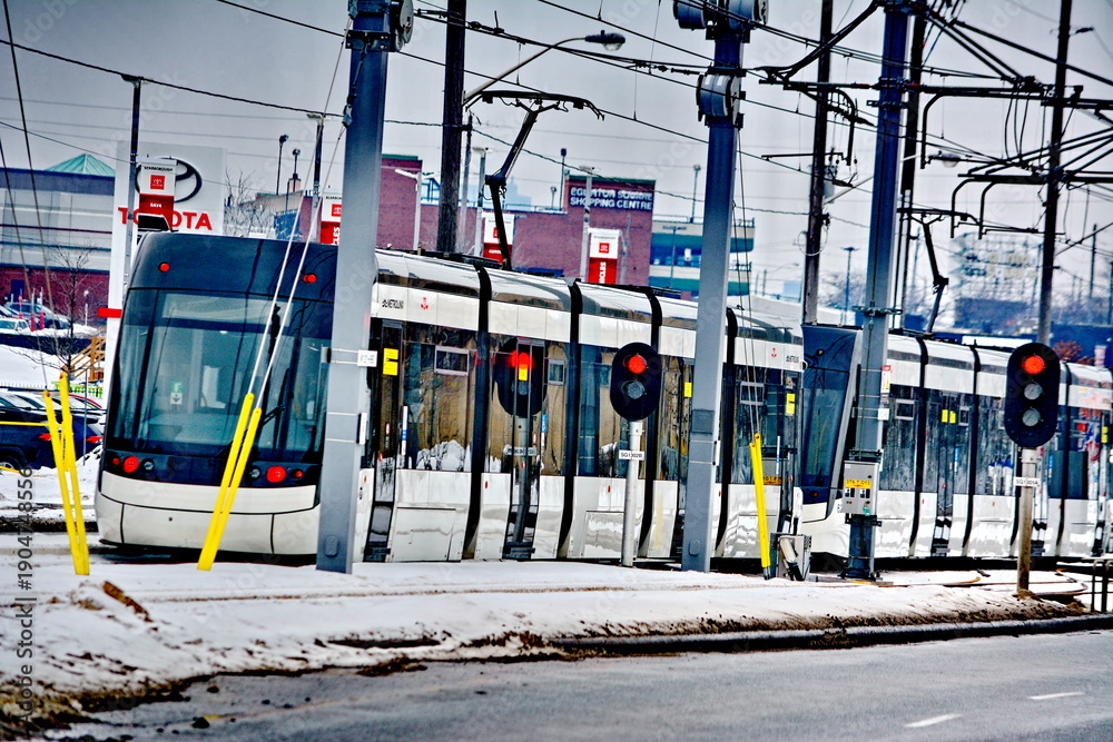 Fototapeta premium Toronto, Ontario, Canada, February 6, 2026: A Metrolinx Eglinton Crosstown LRT test train makes its way along the transit line in Scarborough. This LRT line, after waiting for years to open, is now sc