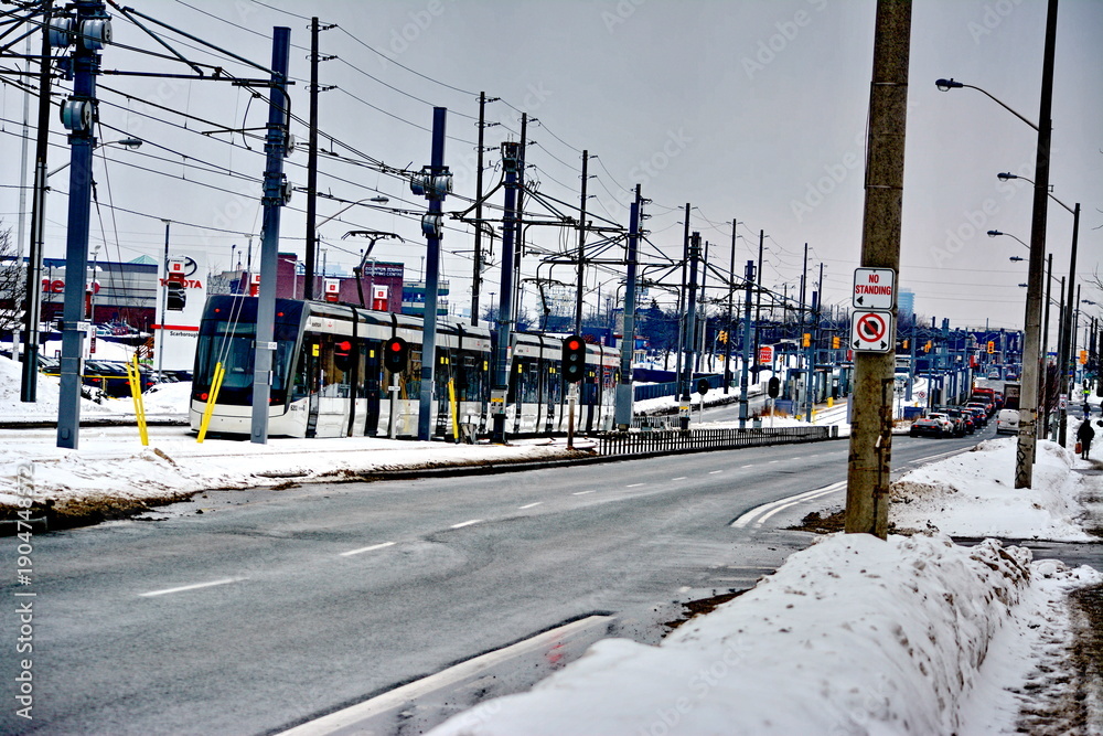 Fototapeta premium Toronto, Ontario, Canada, February 6, 2026: A Metrolinx Eglinton Crosstown LRT test train makes its way along the transit line in Scarborough. This LRT line, after waiting for years to open, is now sc