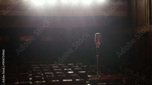 Wide View of Concert Hall with Stage Lights, Chairs and Vintage Microphone Foreground