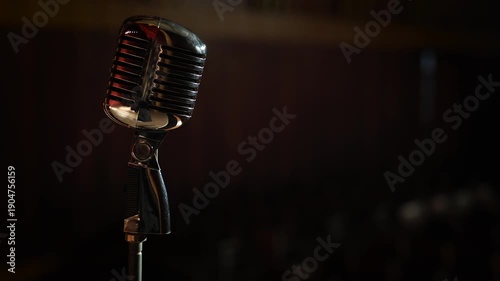 Close-Up Vintage Microphone with Soft-Focus Blurred Audience Chairs Background