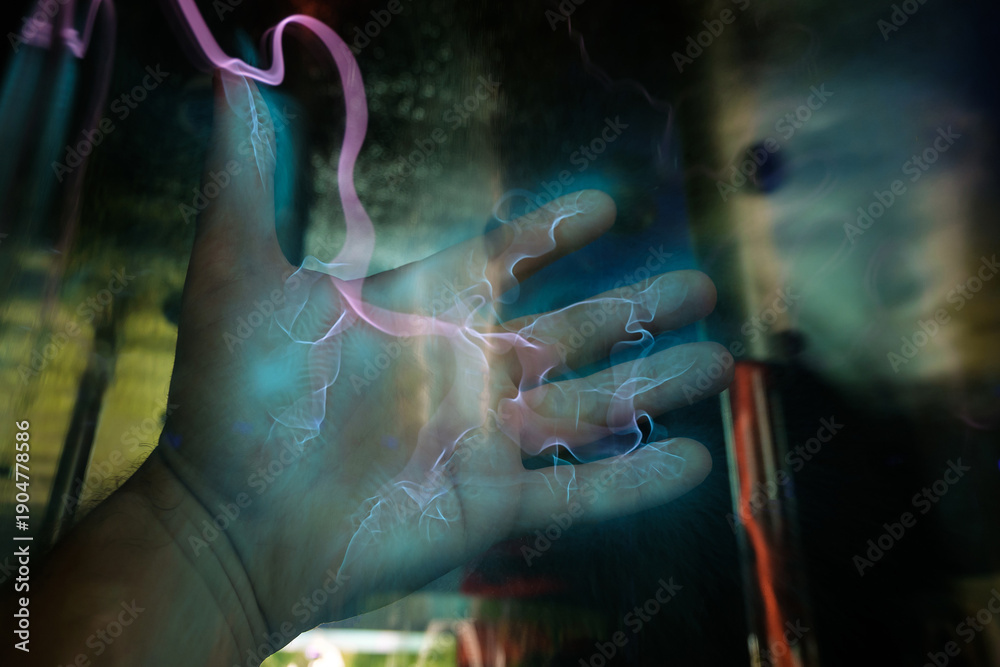 Naklejka premium Lightning generator. Effect of a hand interacting with a plasma device that generates pink lightning-like electrical discharges.