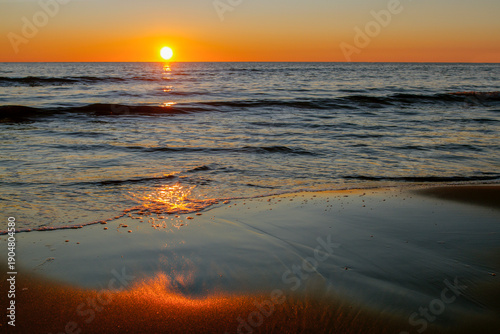 Sea view at sunset. Evening landscape. Beautiful seascape at sunset. Outdoor activities and travel. Suitable as a background. Natural texture. Add text. Close-up. Graphic design.