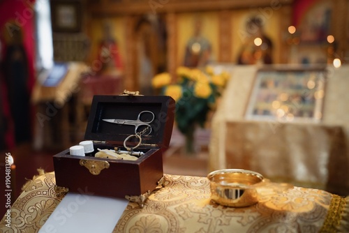 Sacrament of Baptism in Orthodox Church. Items for ceremony, image in yellow-brown tones