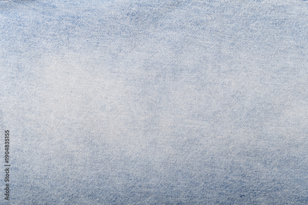 Naklejka premium Light blue denim texture with a soft gradient and fine weave.