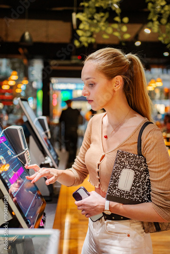 Wallpaper Mural Woman using self service touchscreen kiosk in Vienna Torontodigital.ca