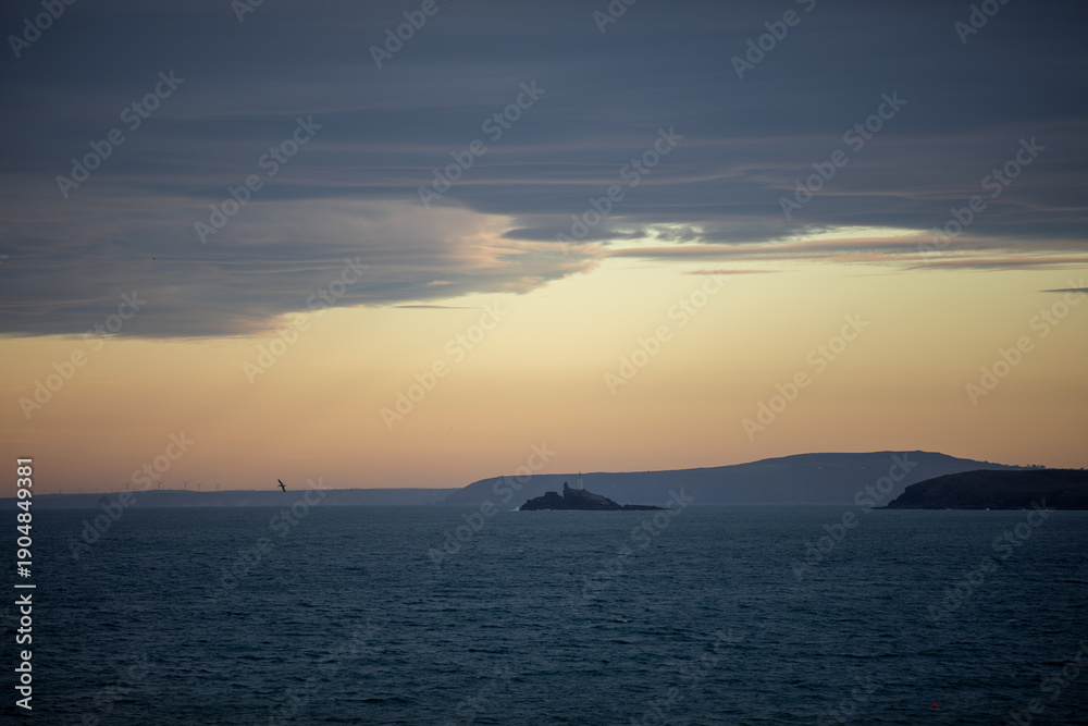 Obraz premium Godrevy Lighthouse at Twilight Viewed from St. Ives, Cornwall.