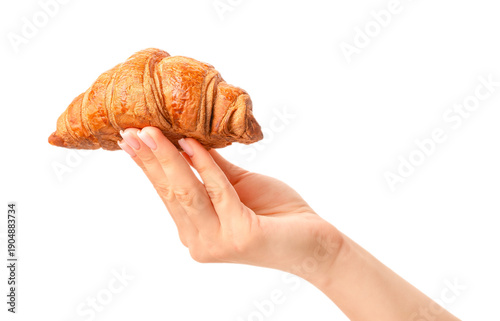 Fresh golden croissant balanced on fingers and held by female hand isolated on white background, ideal for chocolate breakfast concepts, bakery advertising, pastry menus, creative food design,