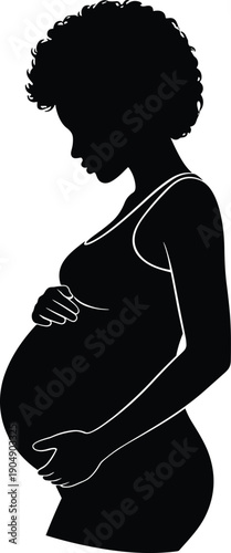 Graceful black and white silhouette of a pregnant African American woman with curly hair holding her belly representing maternity motherhood and expecting a baby