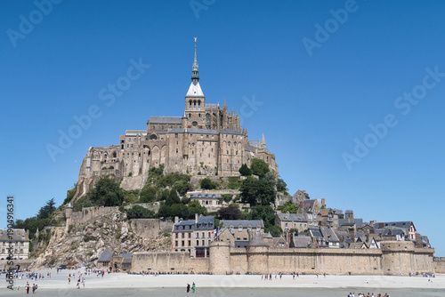 Obraz na plátně Iconic Mont Saint-Michel Landmark - Panoramic view of the iconic medieval Mont Saint-Michel abbey and village in Normandy, France, rising majestically from the flat tidal plains