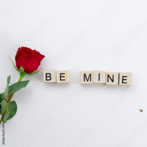 Simple Valentine's Day message BE MINE on white background
