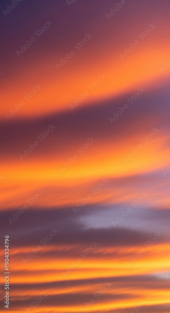 Obraz premium Golden hour atmosphere featuring dramatic orange and purple hues across the vast expanse of the natural sky and soft flowing cloud formations, vibrant, twilight, dramatic