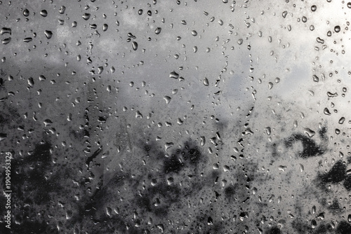 Raindrops on window on a cloudy day