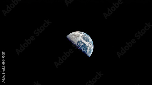 Earth planet half illuminated against the blackness of space with visible clouds oceans and continents curvature of the horizon in the cosmic dark background view