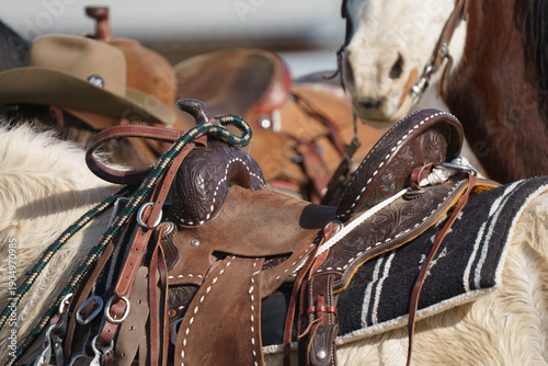 Fényképezés close up of leather western saddle with horse bridle handing over saddle horn