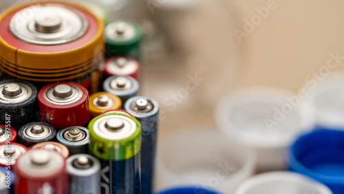 Photos A bunch of batteries are piled up, some of which are green