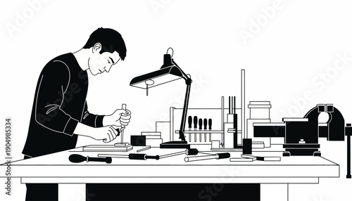 A man works on an object at a cluttered desk with a lamp and various tools nearby in a lab setting.