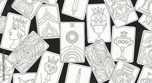 A collection of tarot cards with various symbolic illustrations scattered randomly on a dark background from an overhead viewpoint