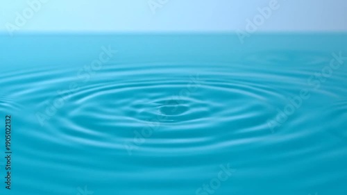 Single Water Droplet on Blue Liquid Surface, purity and minimalism concept