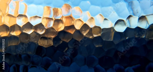 Abstract frosted glass with techno futurism light refraction. Modern honeycomb geometric pattern and blue gold bokeh distortion, ideal for futuristic technology and web backgrounds